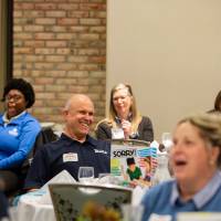 people laughing at tables